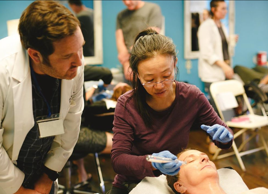 Practitioners learning microneedling with an AcuMicro instructor